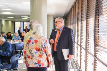 Mark Kovacs talks with people at Alumni Awards 2024
