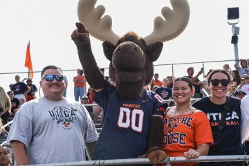 Alex Hodkinson with Trax in bleachers at Homecoming 2025