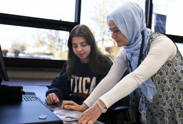 Physics Professor Hava Turkakin works with a student at the computer.
